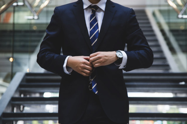 Man Wear a Suit in Front of stairs