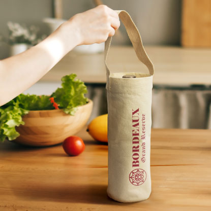Woman holding branded calico wine holder