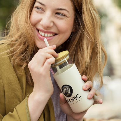 Woman drinking from printed glass bottle