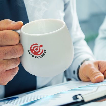 Office worker holding a promotional coffee mug