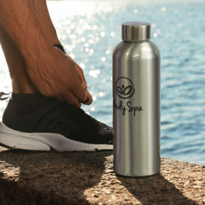 Promotional drink bottle next to tying running shoes