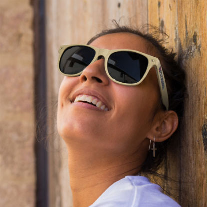 Woman wearing sunglasses made from wheat straw