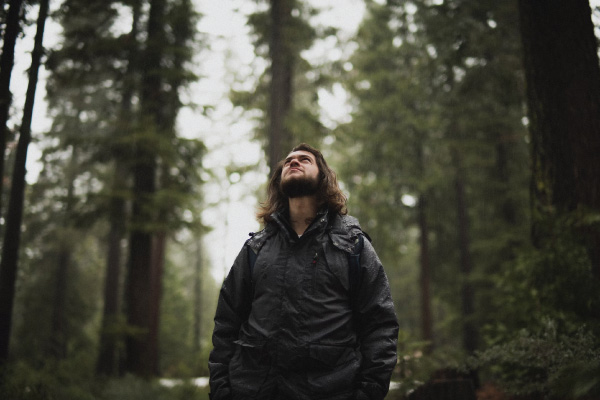 Man in forest wearing a jacket