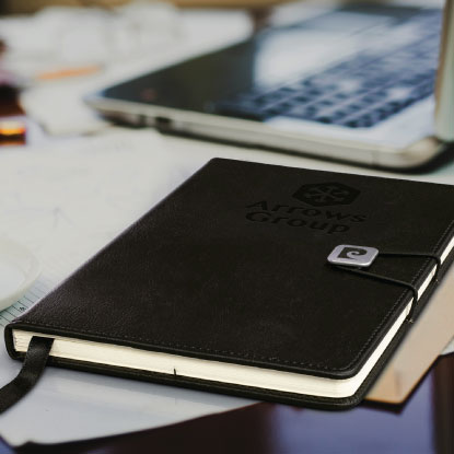 black branded notebook on desk