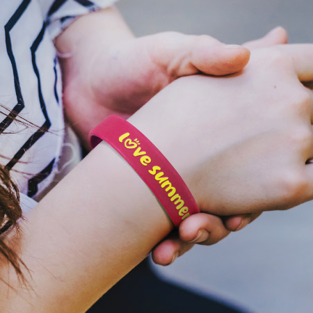 Wearing promotional silicone band with love summer on it
