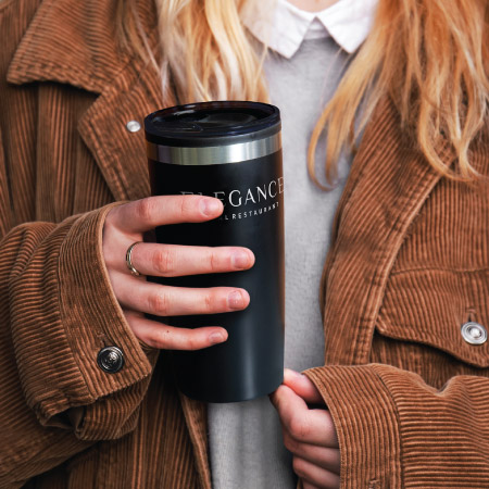 Woman holding promotional travel mug