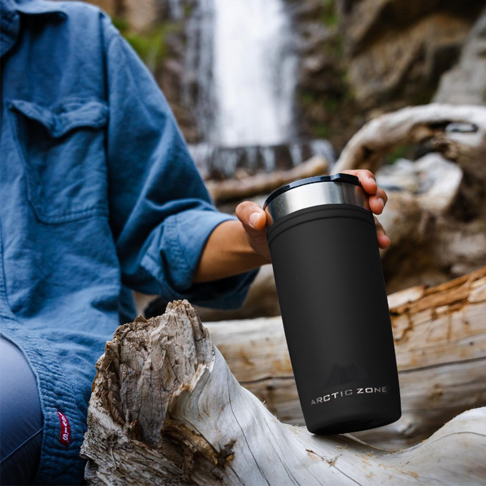 Government Merchandise - Insulated Reusable Tumbler for Government Campaigns – Arctic Zone Australia Black insulated tumbler held beside a waterfall during a government work visit in Australia.