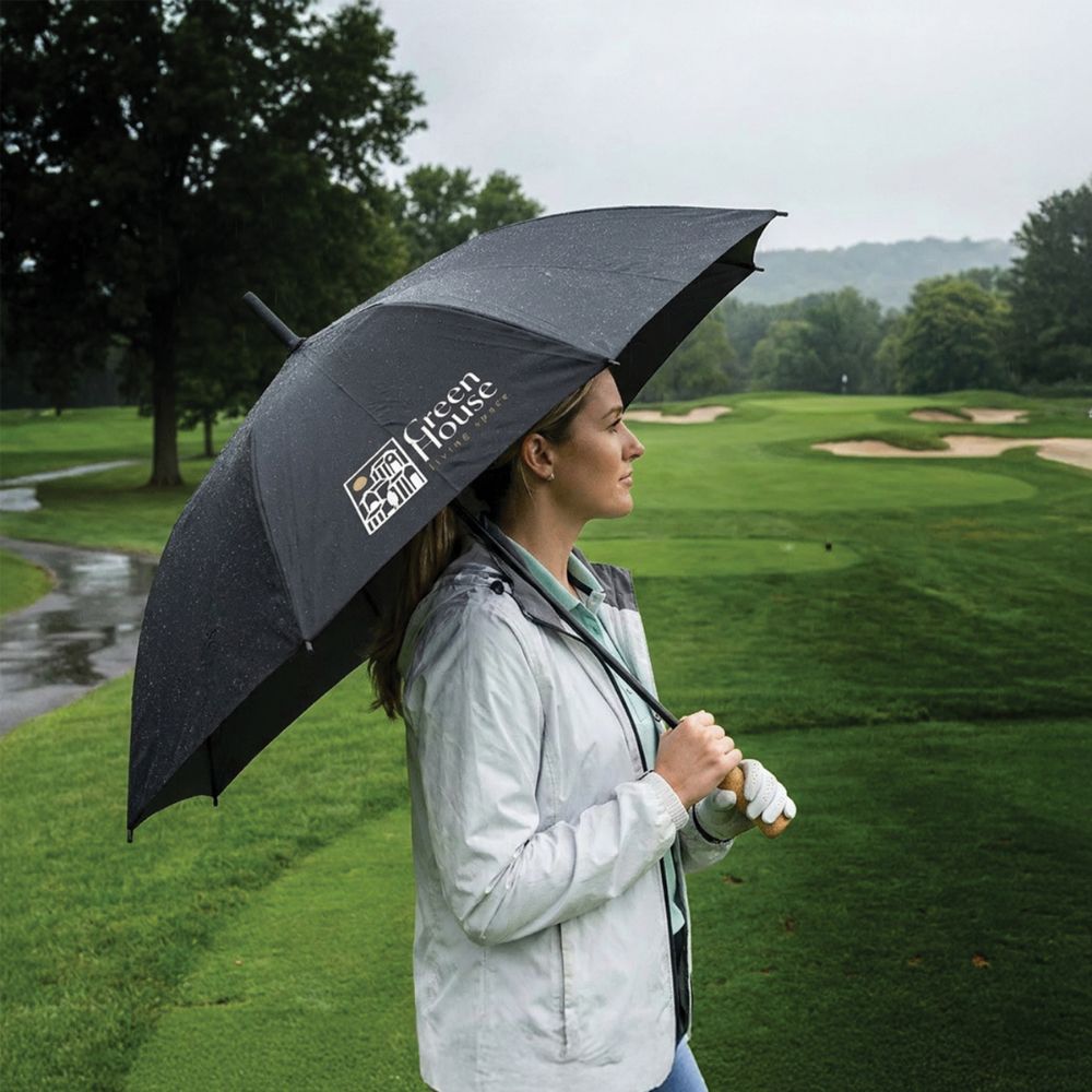 Branded Umbrella Corporate Christmas Gift Branded golf umbrella being used on a rainy golf course, a practical corporate Christmas gift idea for clients and employees.